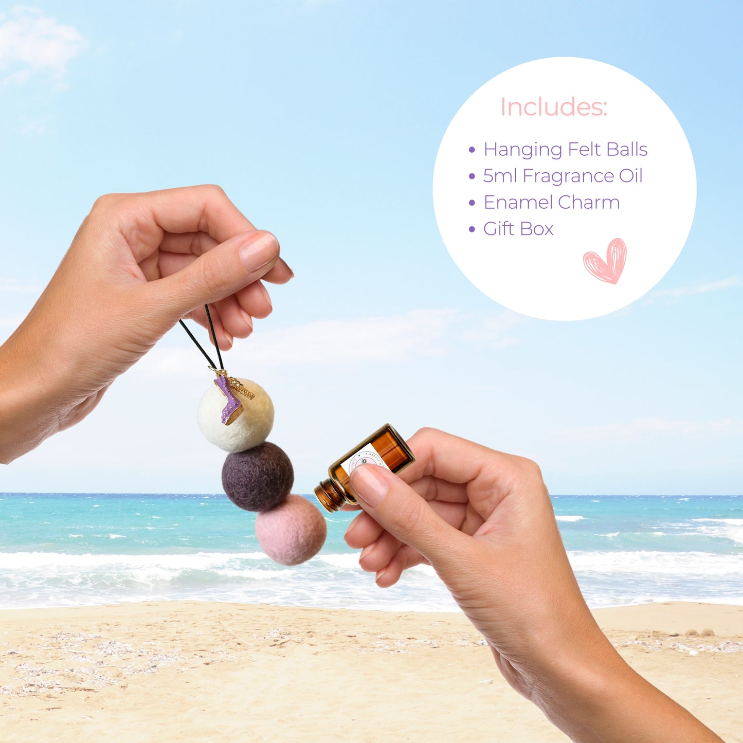 Hands apply French Pear essential oil to a felt ball diffuser featuring a glittery purple boot charm, beside a product details list on a beach scene.