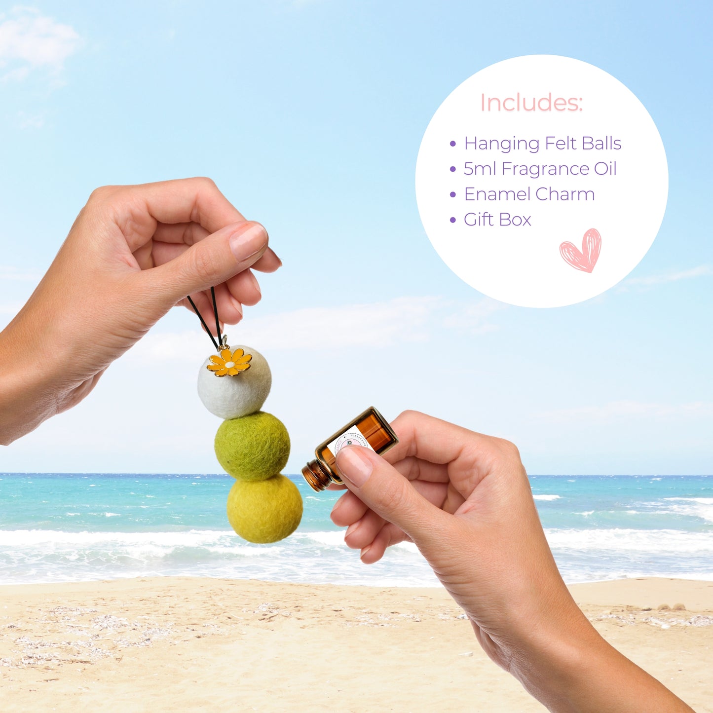 Hands applying essential oil to reusable wool felt car diffuser with a yellow enamel flower charm, with beach background and included kit contents listed