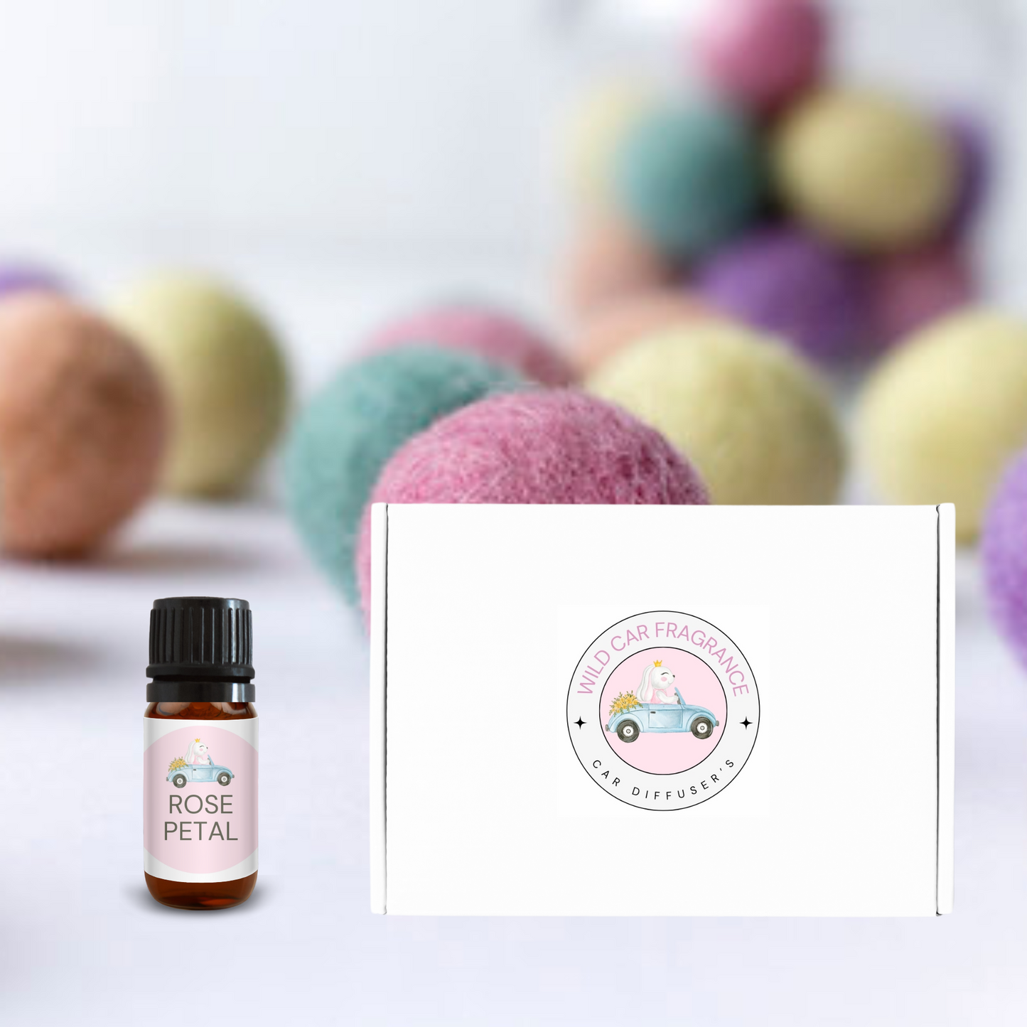 Rose Petal bottle of essential oil next to gift box with hanging car diffuser inside