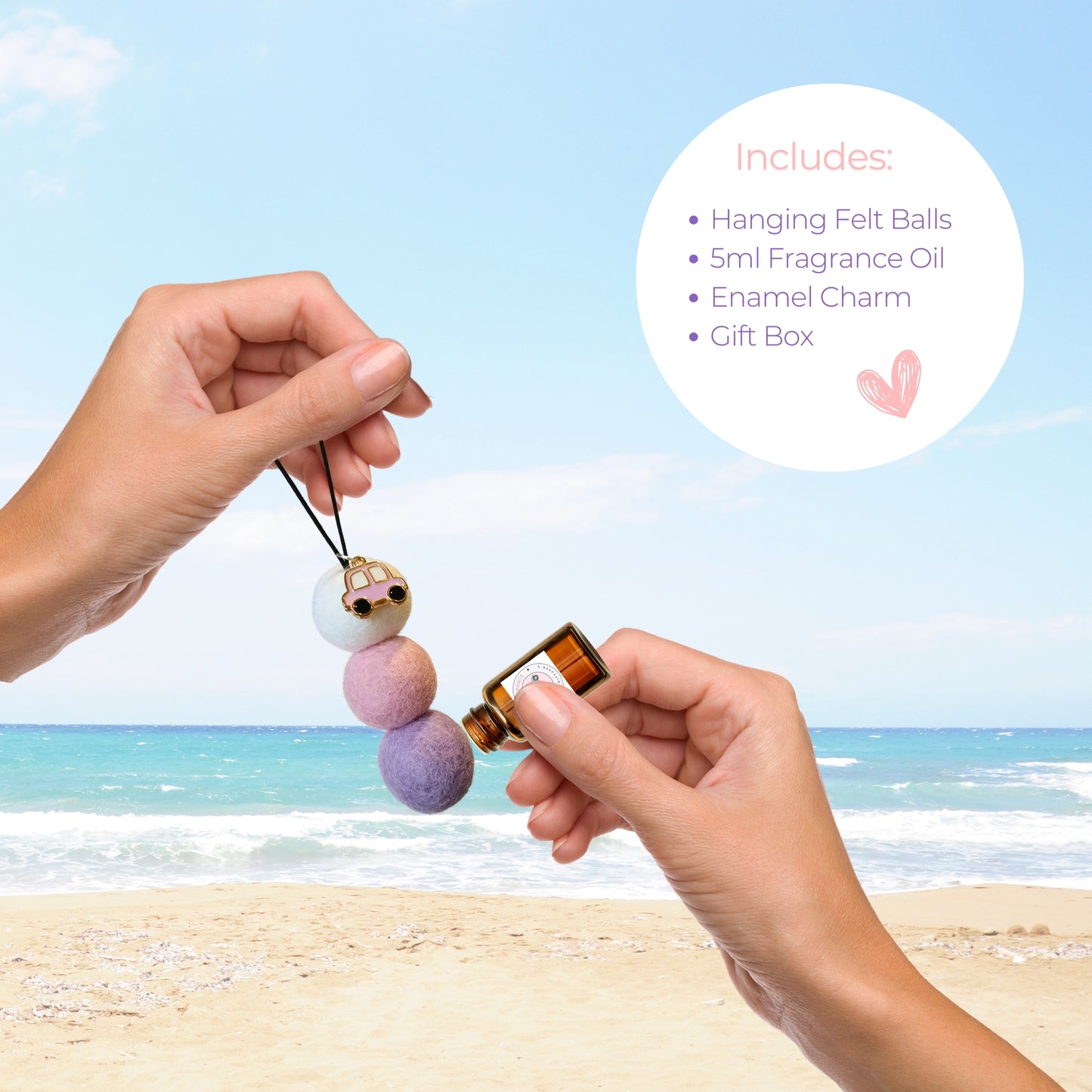 Woman applying Sweet Pea & Jasmine fragrance oil to pastel felt ball car diffuser with pink car charm at the beach.
