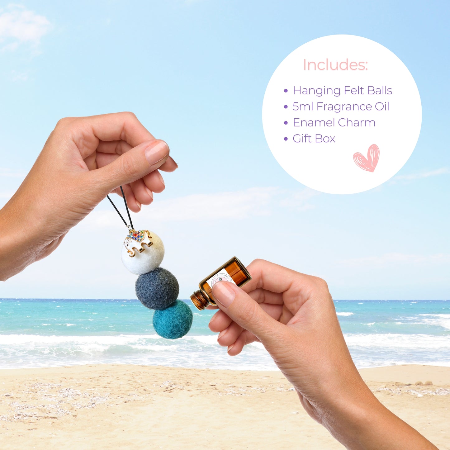 Hands applying jasmine essential oil to a felt ball car diffuser with enamel elephant charm, with product components listed beside