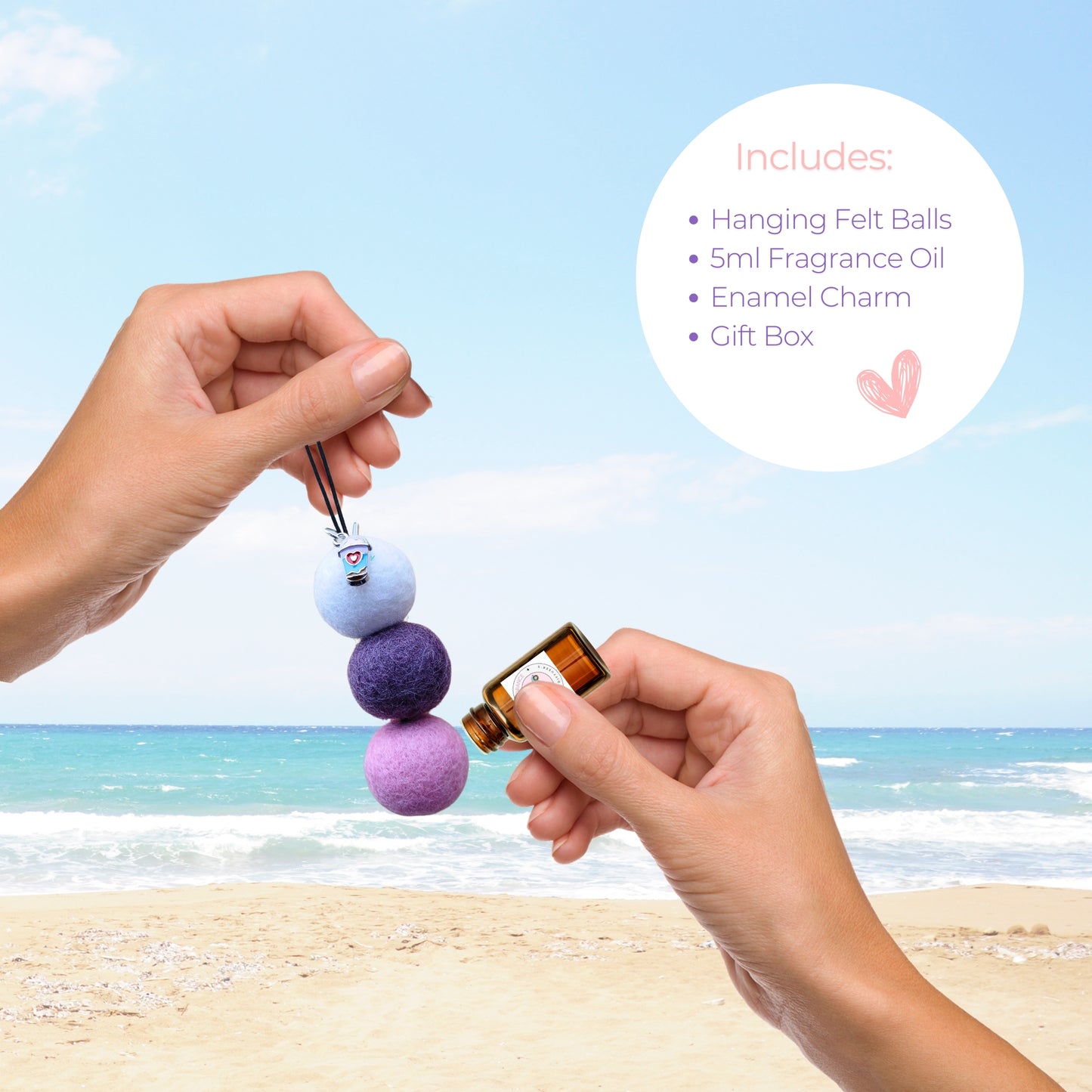 Hands apply fragrance oil to purple felt ball car air freshener by the beach.