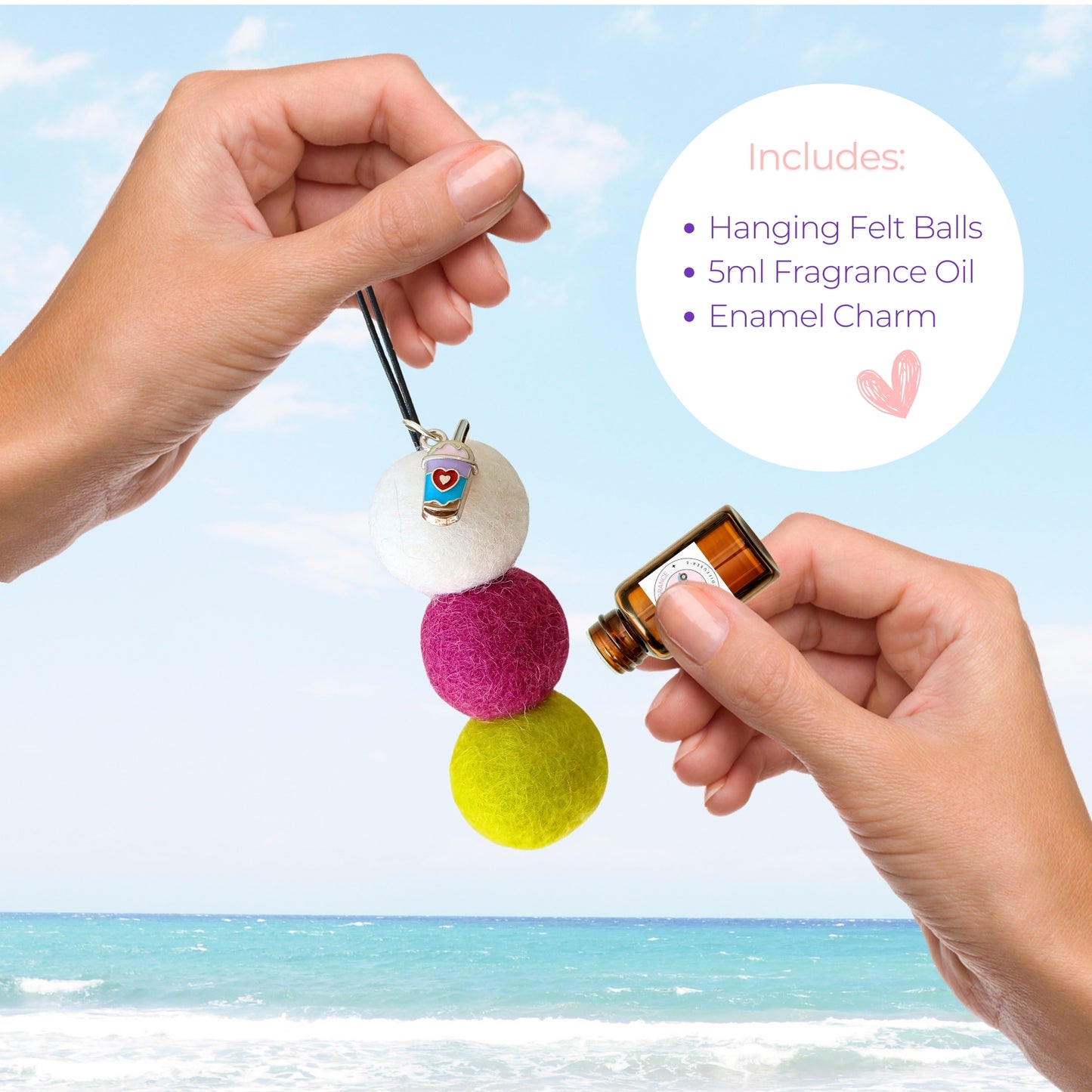 Colorful hanging felt ball with a small bottle of fragrance oil against a beach background