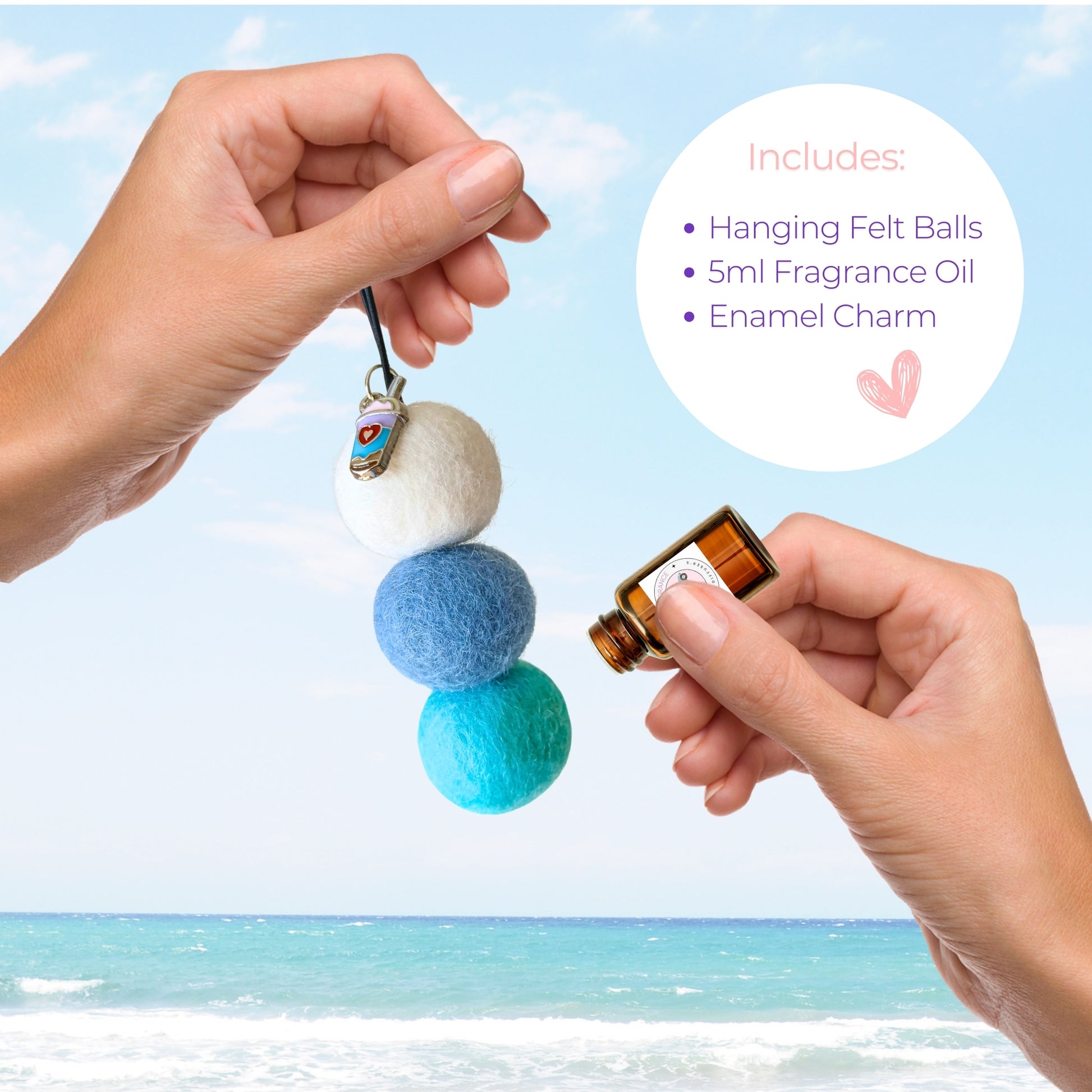 Hanging felt ball diffuser with fragrance oil and enamel charm against a beach background