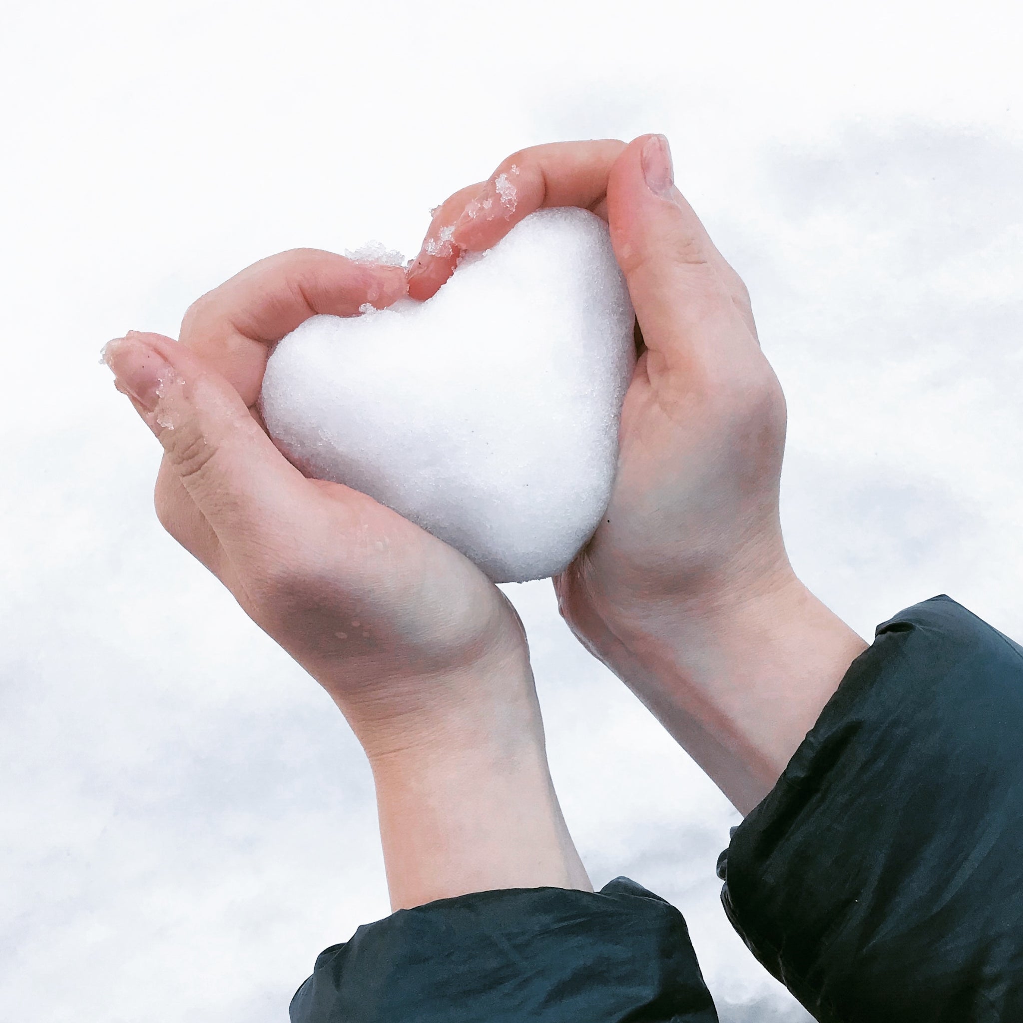 Hand holding felt wool shaped like a heart